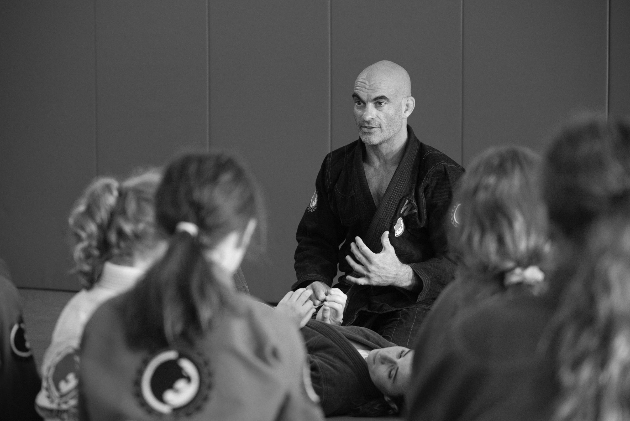 A man teaching karate to a group of people.